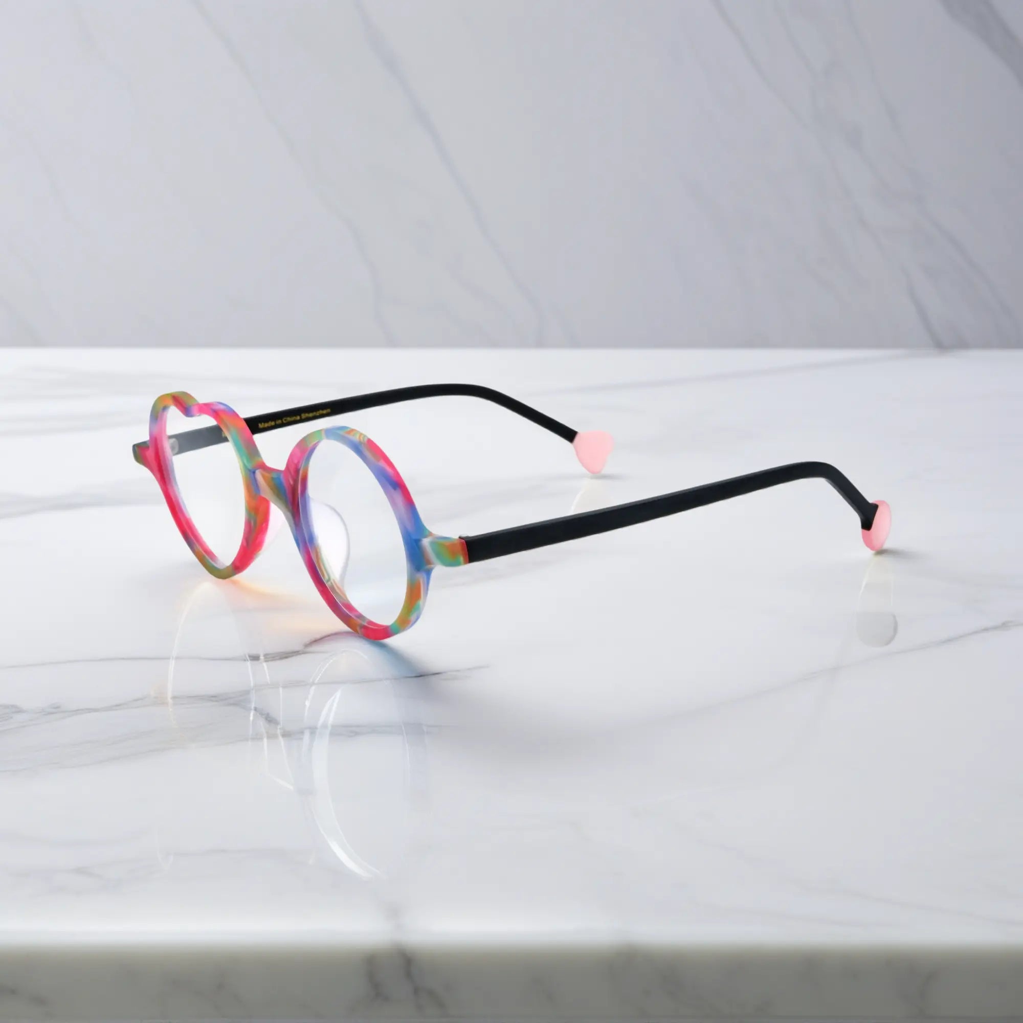 Side view of Rainbow Twist variant, showcasing frame thickness and temple arm structure. Multi-colored design with a swirl of rainbow shades in matte finish.